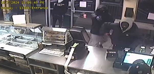 Suspects robbing store.