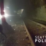 Police officer rescues man from oncoming train.