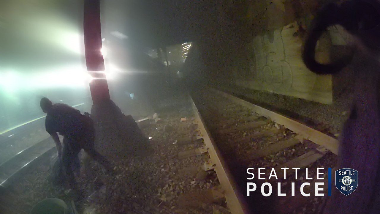 Police officer rescues man from oncoming train.