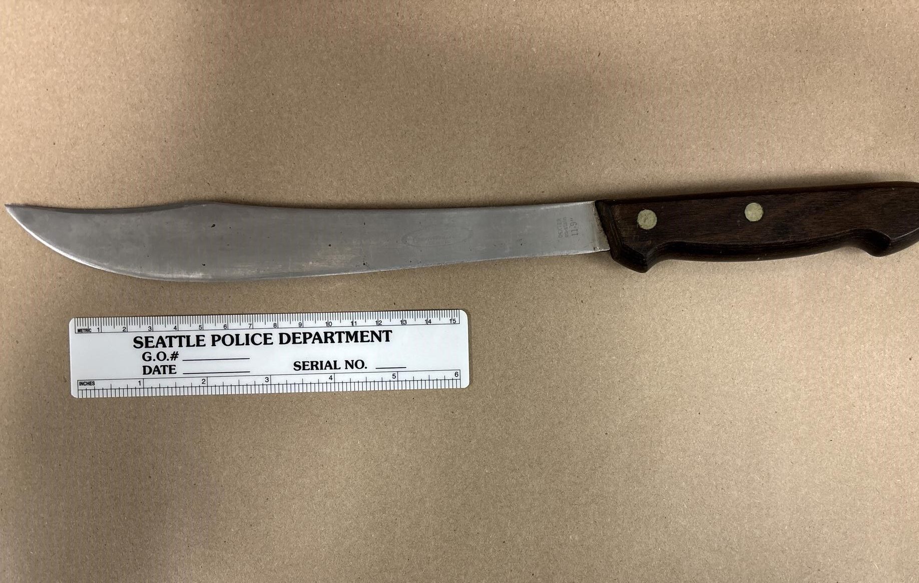 Long stainless-steel knife with brown handle.  