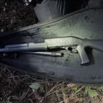 Black shotgun inside carrying case