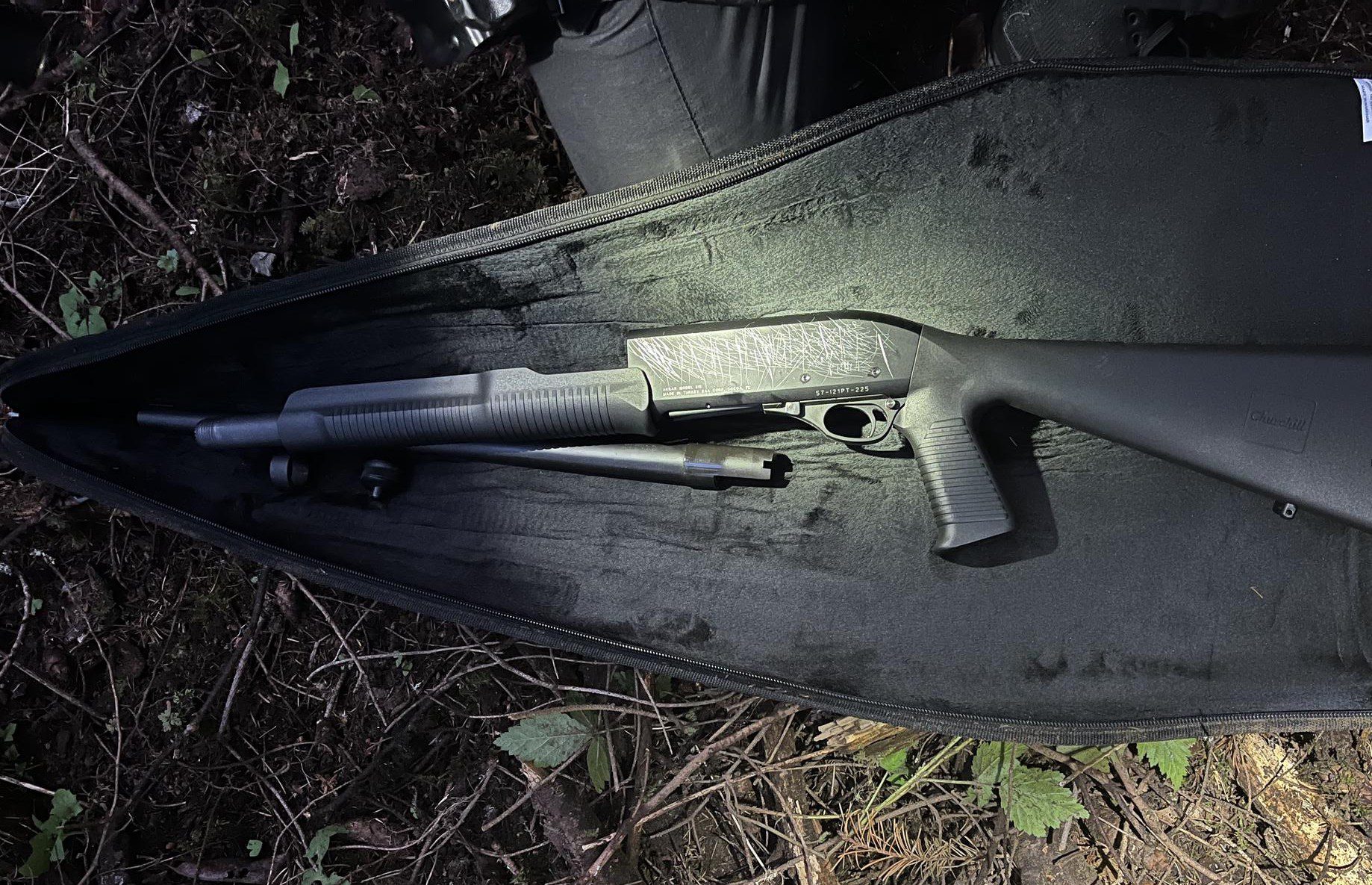 Black shotgun inside carrying case