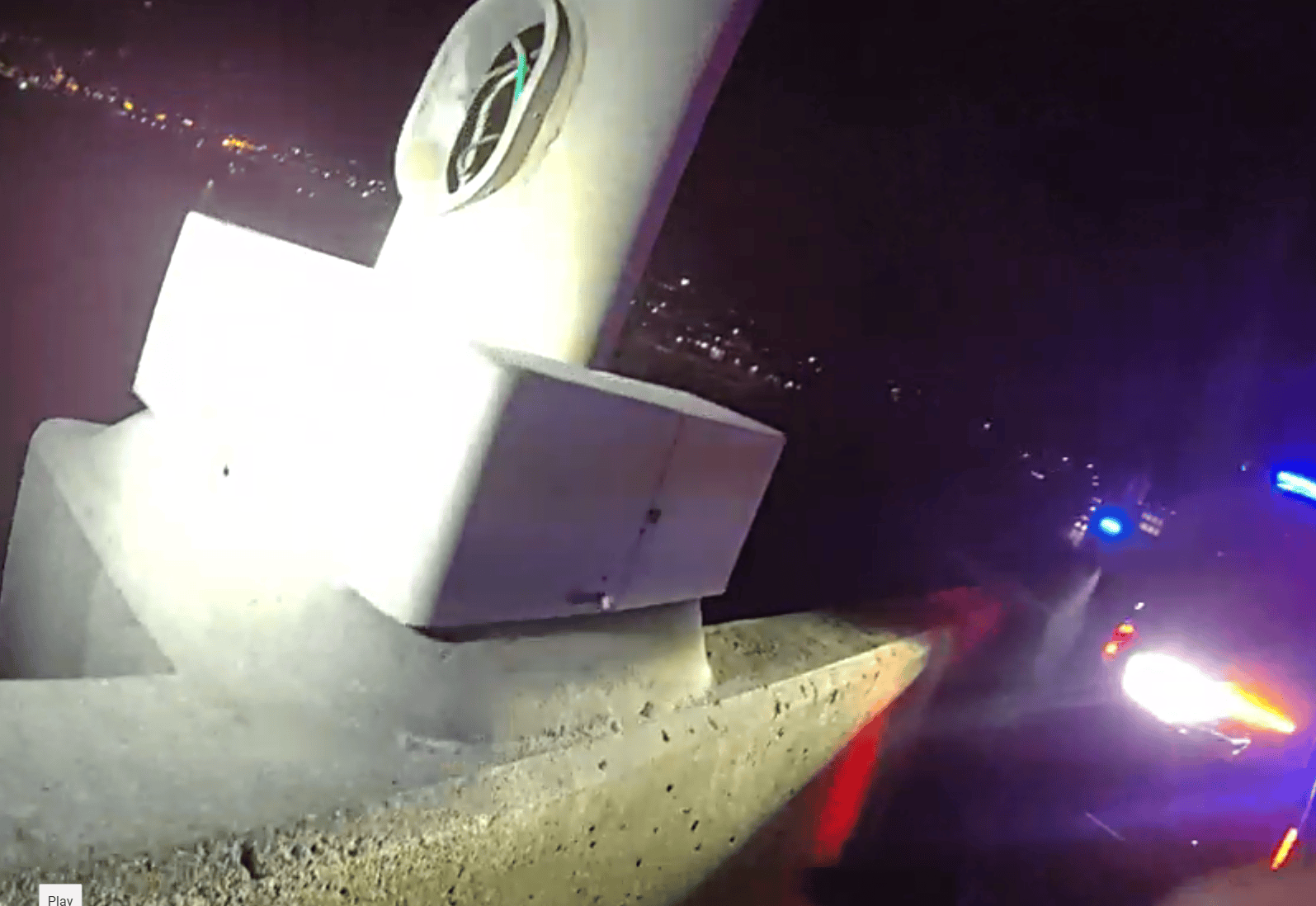 metal light pole on bridge with access cover missing and copper wire showing.